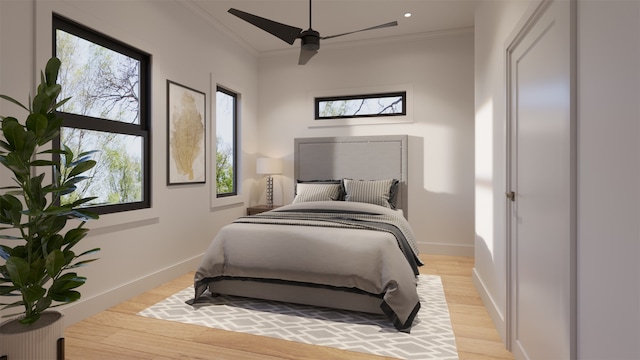 bedroom featuring ceiling fan, crown molding, and light wood-type flooring