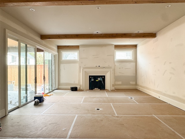 unfurnished living room with beamed ceiling