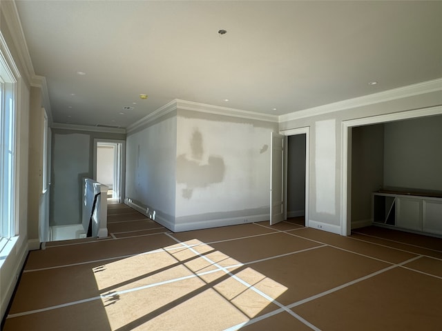 interior space with dark tile patterned flooring and crown molding