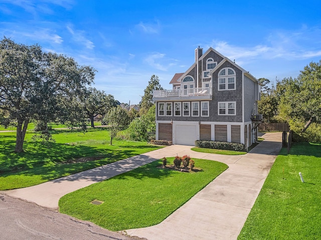 view of front of home with a front yard and a garage