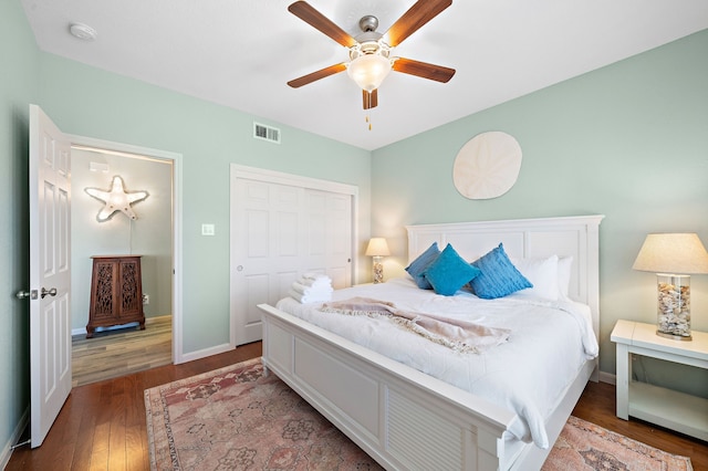 bedroom featuring dark hardwood / wood-style flooring, ceiling fan, and a closet