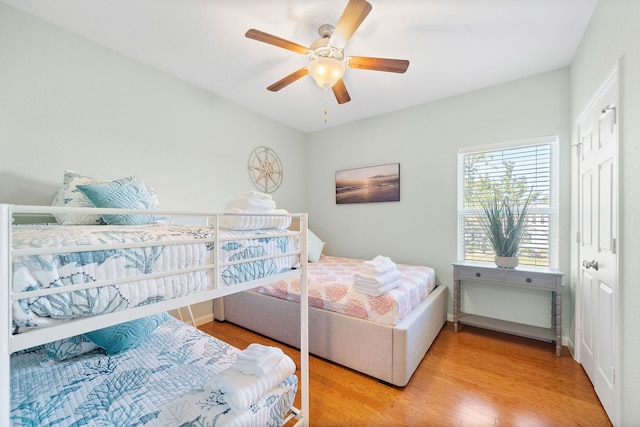 bedroom with light hardwood / wood-style floors and ceiling fan