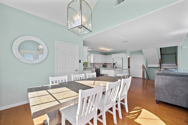 dining area with a notable chandelier and light wood-type flooring