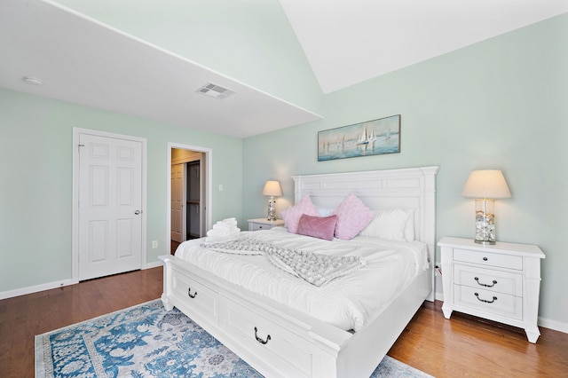 bedroom featuring hardwood / wood-style floors and vaulted ceiling