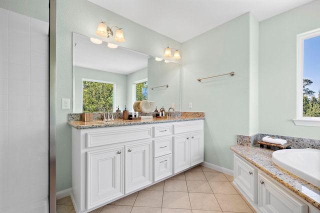 bathroom featuring double sink vanity, tile flooring, and a bathtub