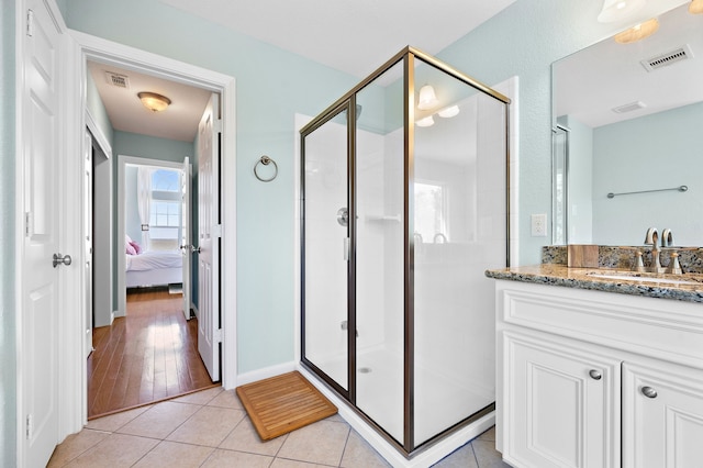 bathroom featuring vanity, a shower with door, and hardwood / wood-style floors