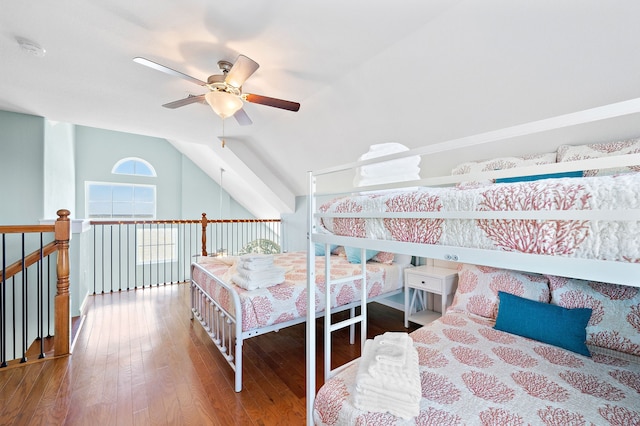 bedroom with ceiling fan, lofted ceiling, and dark hardwood / wood-style floors