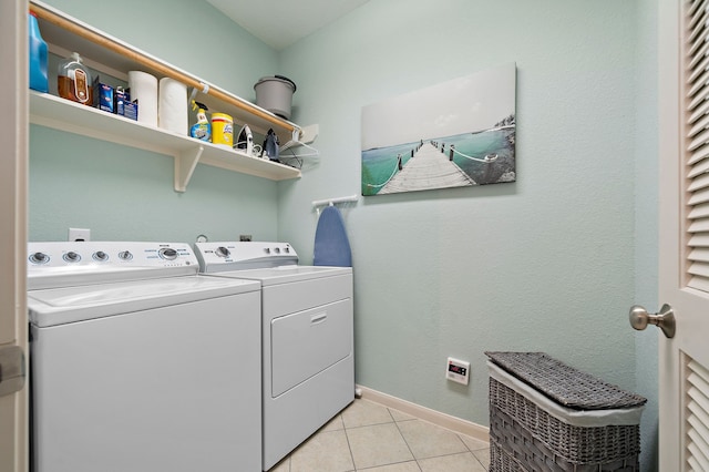 washroom with light tile floors and independent washer and dryer