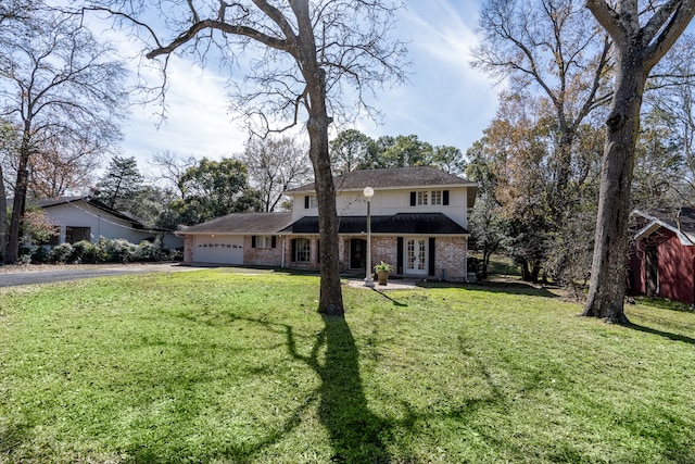 front of property with a front yard and a garage