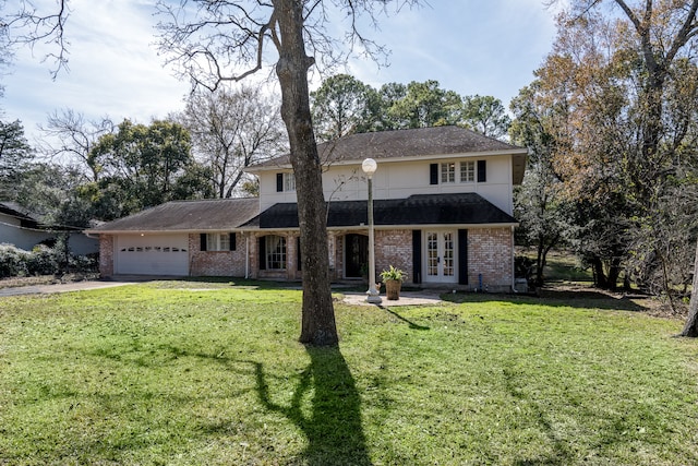 front of property with a front yard, french doors, and a garage