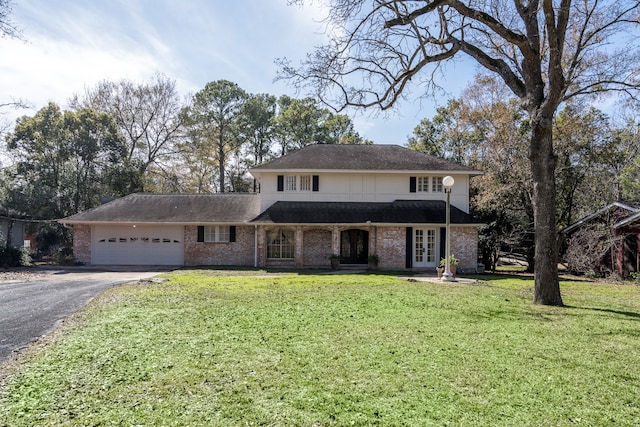 front of property with a front lawn and a garage