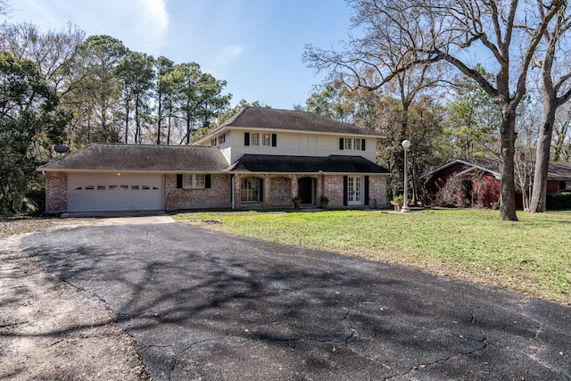 front of property with a front lawn and a garage