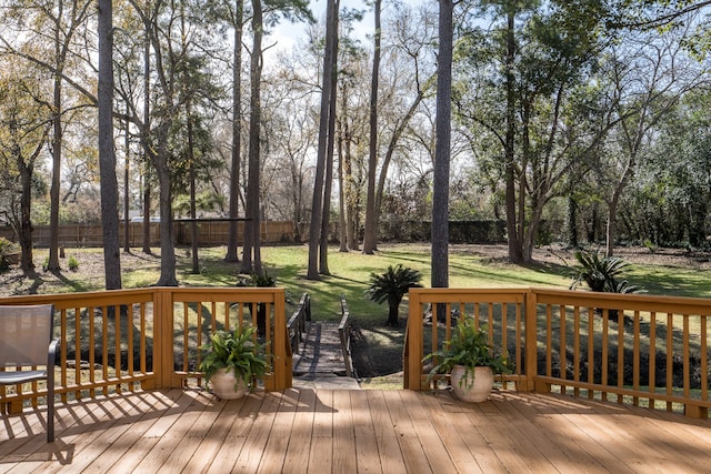 wooden terrace featuring a yard