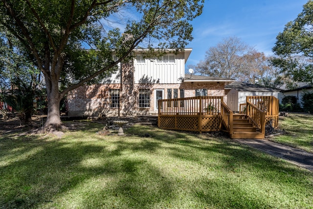 back of property featuring a wooden deck and a yard