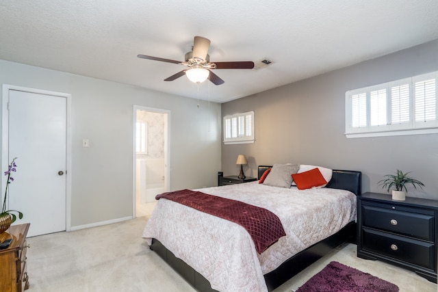 carpeted bedroom featuring ceiling fan and connected bathroom