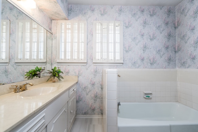 bathroom with a bathing tub and large vanity