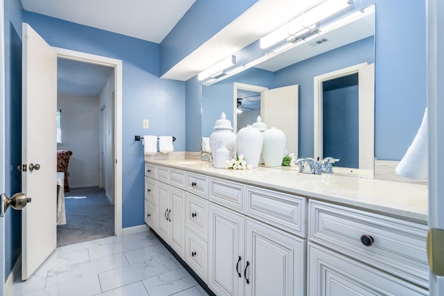 bathroom with ceiling fan, double sink vanity, and tile floors