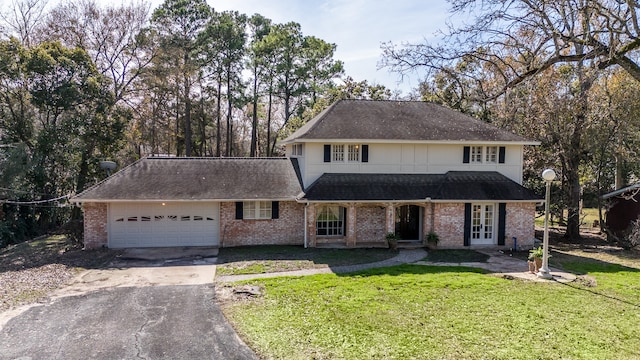 view of property with a front lawn and a garage