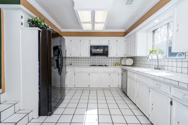 kitchen featuring black appliances, light tile flooring, sink, white cabinets, and tasteful backsplash