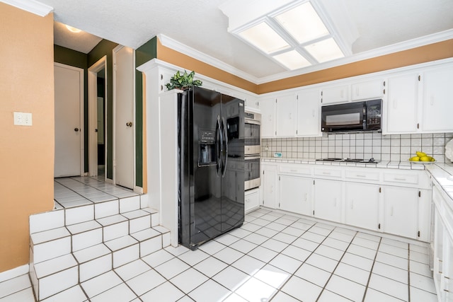 kitchen featuring white cabinets, backsplash, light tile flooring, and black appliances