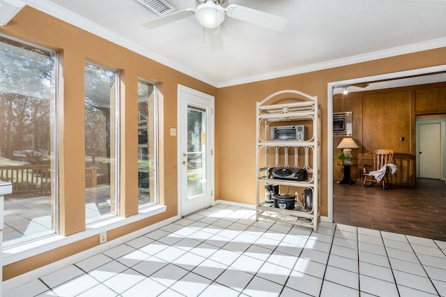 sunroom / solarium featuring plenty of natural light and ceiling fan