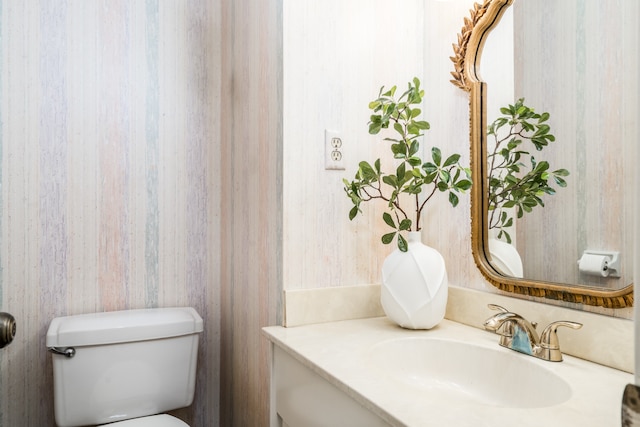 bathroom featuring toilet and vanity