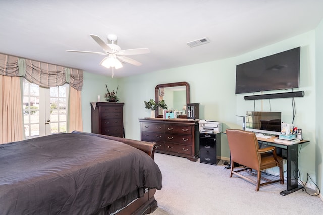 bedroom with ceiling fan, light carpet, and french doors