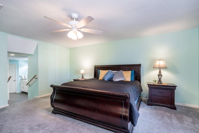 bedroom featuring ceiling fan, connected bathroom, and dark colored carpet