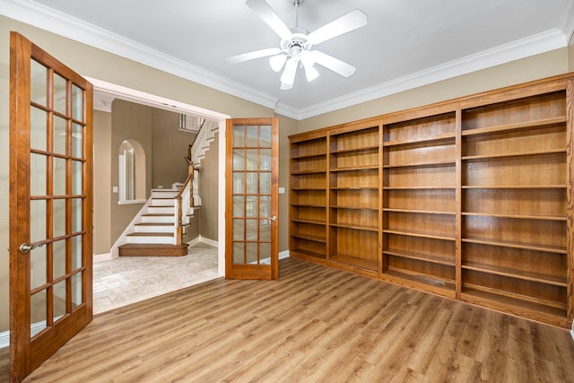 empty room with ceiling fan, ornamental molding, light hardwood / wood-style floors, and french doors