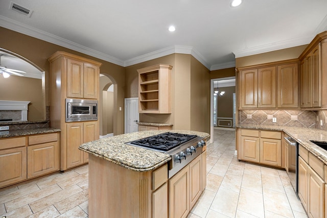 kitchen featuring light tile floors, appliances with stainless steel finishes, backsplash, and ceiling fan with notable chandelier