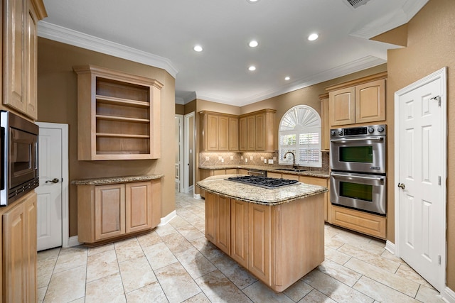 kitchen featuring sink, light stone counters, a kitchen island, stainless steel appliances, and tasteful backsplash