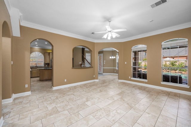 tiled empty room with ceiling fan and crown molding