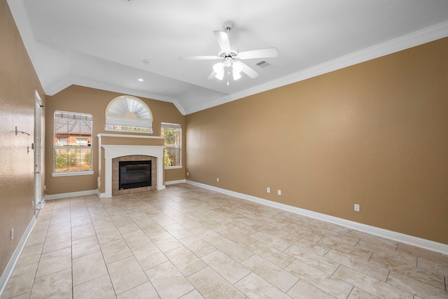 unfurnished living room featuring crown molding, light tile floors, ceiling fan, and a tiled fireplace