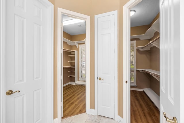 walk in closet featuring light hardwood / wood-style flooring