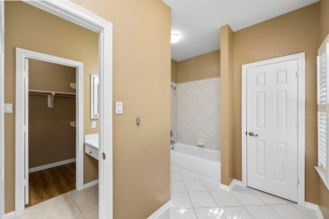 bathroom featuring vanity, washtub / shower combination, and wood-type flooring