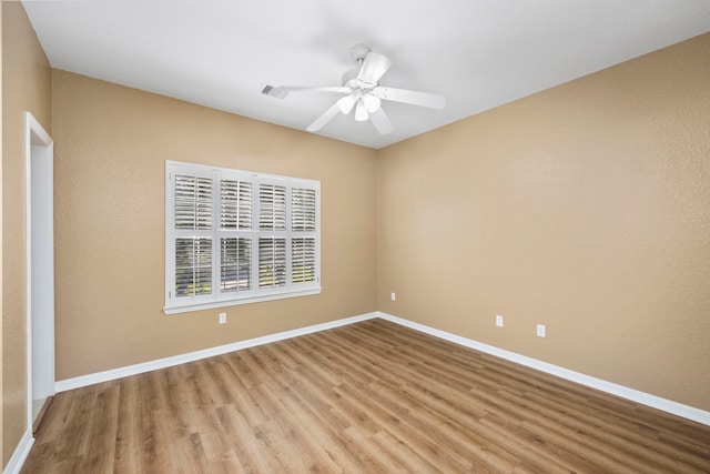 empty room with light hardwood / wood-style floors and ceiling fan