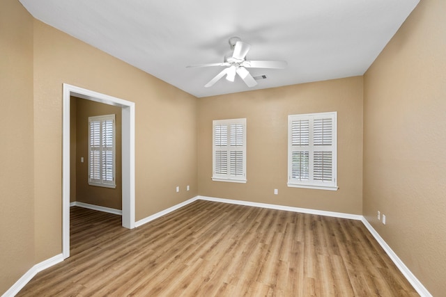 unfurnished room with ceiling fan and light wood-type flooring