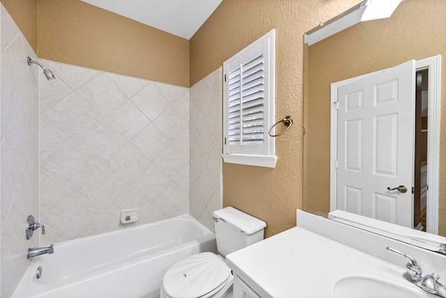 full bathroom with tiled shower / bath combo, toilet, and large vanity