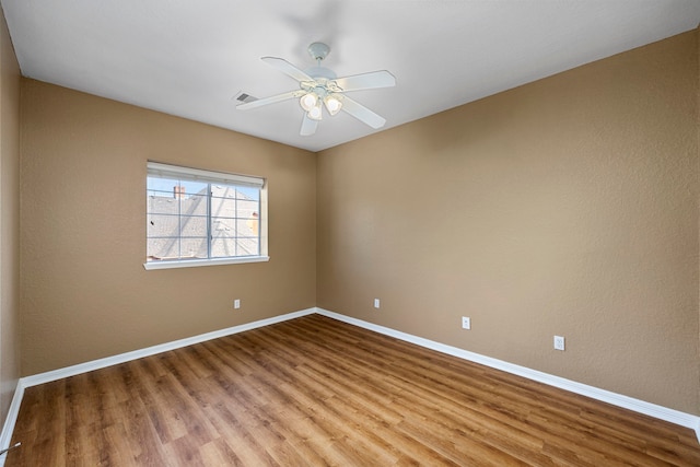 spare room featuring ceiling fan and light hardwood / wood-style floors