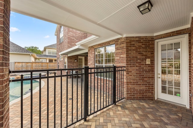 balcony featuring a fenced in pool