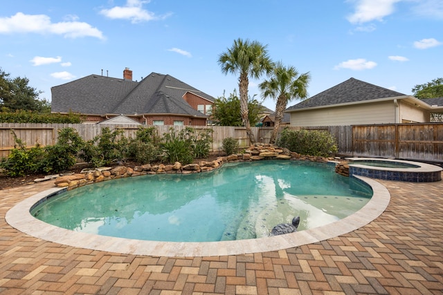 view of swimming pool with an in ground hot tub