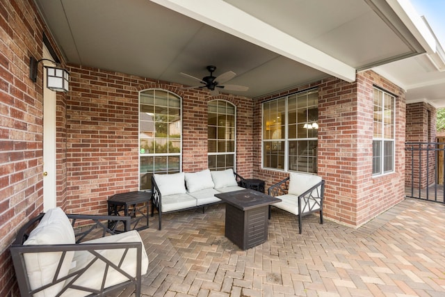 view of terrace with an outdoor living space and ceiling fan