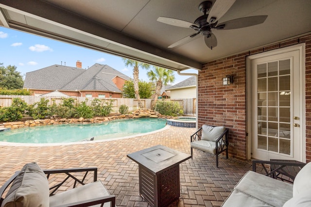 view of swimming pool with a patio area and ceiling fan