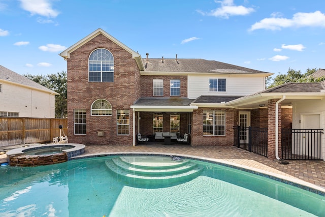 view of pool with a patio and an in ground hot tub