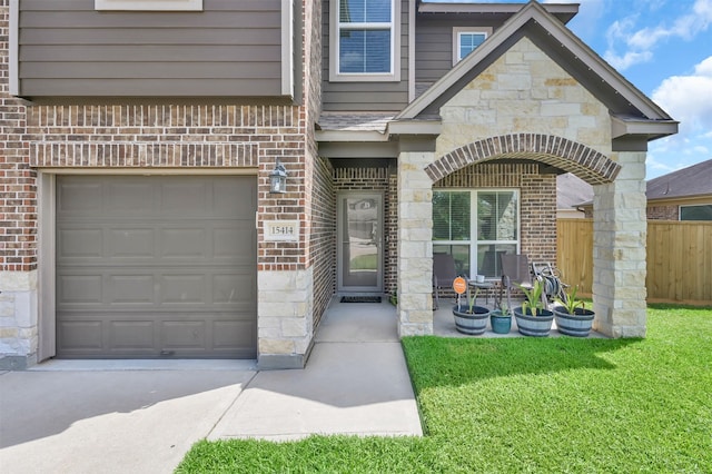 doorway to property with a lawn and a garage