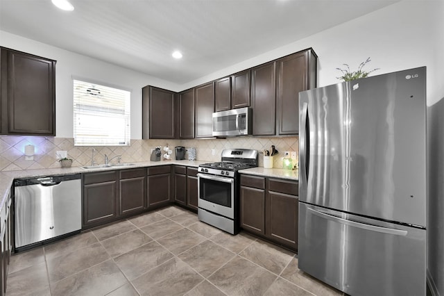 kitchen featuring appliances with stainless steel finishes, tasteful backsplash, and dark brown cabinetry