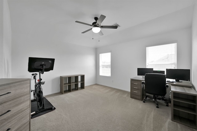 carpeted home office featuring ceiling fan