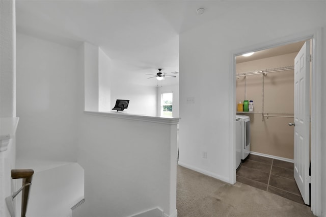 hall featuring washing machine and clothes dryer and dark colored carpet