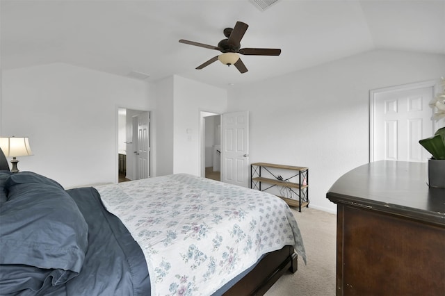 bedroom featuring light colored carpet, connected bathroom, vaulted ceiling, and ceiling fan