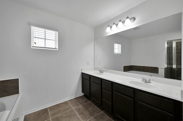 bathroom with large vanity, a washtub, double sink, and tile flooring